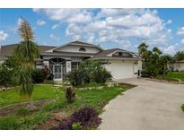 Charming single-story home with a well-manicured lawn and a two-car garage at 23420 Peachland Blvd, Port Charlotte, FL 33954