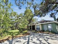 Charming one-story home with mature trees and a paved driveway at 3603 E Sterling Cir, Tampa, FL 33629