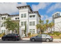 Beautiful three-story townhome with white facade, decorative tower, and manicured landscaping at 5351 Bridge St # 9, Tampa, FL 33611