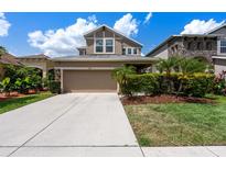 Charming two-story home with landscaped yard and a spacious two car garage at 7699 Windchase Way, Wesley Chapel, FL 33545