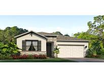 Charming single-story home featuring a two-car garage and stone accents at 7763 Wheat Stone Dr, Zephyrhills, FL 33540