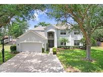 Charming two-story home with a well-manicured lawn, attached garage, and inviting curb appeal at 808 Hickory Glen Dr, Seffner, FL 33584
