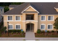 Inviting exterior view of a two-story apartment building with landscaped grounds and an accessible entrance at 9516 Newdale Way # 101, Riverview, FL 33578