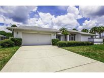 Charming single-story home with a two-car garage and well-maintained landscaping at 128 Torrington St, Port Charlotte, FL 33954