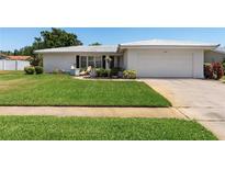 Charming single-story home with a well-maintained front lawn and neutral palette at 14542 Anchorage Cir, Seminole, FL 33776