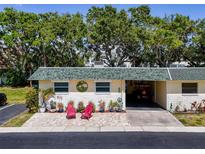 Charming single-story home features a well-kept lawn, carport, and inviting curb appeal at 149 Sky Loch Dr E, Dunedin, FL 34698