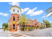 Charming multi-story red brick building featuring unique architectural details and lush landscaping at 1910 E Palm Ave # 10209, Tampa, FL 33605