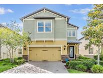 Charming two-story home showcasing well-manicured landscaping and a welcoming facade at 3303 Monroe Meadows Dr, Odessa, FL 33556