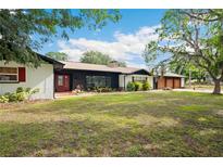 Charming single story home with a lush lawn and mature trees creates a beautiful curb appeal at 36601 Roberts Rd, Dade City, FL 33525