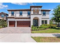 Stunning two-story home showcasing a 3-car garage and tile roof in a beautifully landscaped setting at 4275 Burdick Loop, Odessa, FL 33556