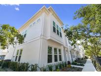 Beautiful white townhouse with ample windows and fresh landscaping at 4717 W Mccoy St # 2, Tampa, FL 33616
