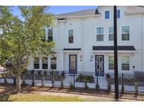 Charming townhome showcasing a well-manicured yard and neutral-toned exterior, complete with a stylish fence at 4717 W Mccoy St # 2, Tampa, FL 33616