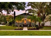 Charming home featuring mature palm trees, meticulous landscaping, and a welcoming front entryway at 4767 6Th N Ave, St Petersburg, FL 33713