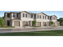 Inviting townhome with neutral paint, dark shutters, garage, landscaping and well manicured lawn at 5137 Benjamin Eric St, Zephyrhills, FL 33541