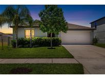Charming single Gathering home showcasing a well manicured lawn and inviting curb appeal, perfect for families at 5208 Dandelion St, Apollo Beach, FL 33572