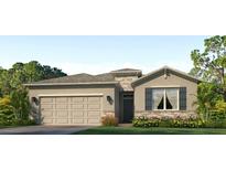 Charming single-story home with a neutral color palette, a two-car garage, and landscaped yard at 7783 Wheat Stone Dr, Zephyrhills, FL 33540