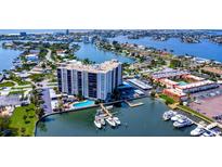 Aerial shot of the luxurious waterfront condo offering stunning views, pool, and boat docks at 10355 Paradise Blvd # 413, Treasure Island, FL 33706