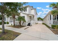Charming two-story home featuring a well-manicured lawn, and a private driveway leading to a detached garage at 11227 Moultrie Pl, Tampa, FL 33625