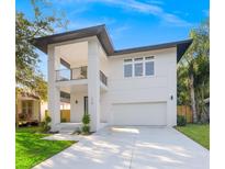 Stunning modern two story home featuring a balcony, a two car garage and lush landscaping at 116 W Stanley St, Tampa, FL 33604