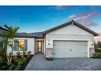 Charming single-Gathering home featuring a two-car garage, stone accents, and beautifully landscaped front yard at 16419 Sapphire Point Dr, Lakewood Ranch, FL 34211