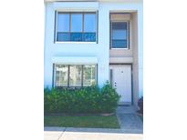 Charming two-story home featuring manicured shrubs, neutral paint, and well-lit entryway at 1849 Abrico Dr # K9, Lutz, FL 33558