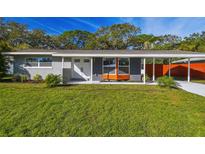 Charming single-story home with a well-manicured lawn and neutral paint scheme at 2042 Craft Ln, Sarasota, FL 34239