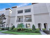A three-story condominium building with beautifully manicured landscaping provides excellent curb appeal at 214 S Audubon Ave, Tampa, FL 33609