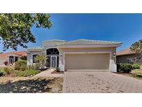 Charming single-story home featuring a two-car garage, well-manicured landscaping, and a welcoming entrance at 2416 Caraway Dr, Venice, FL 34292