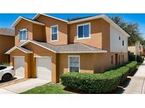 Two-story townhome with a private garage and beautiful landscaping at 2530 Sandy Beach Ln, Clearwater, FL 33763