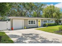 Charming single-story home with a well-manicured lawn and bright yellow front door at 3302 W Beaumont St, Tampa, FL 33611