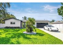 Charming single-story home with well-manicured lawn, modern exterior, and attached garage at 3436 Manatee Se Dr, St Petersburg, FL 33705
