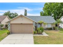 Charming single-story home with well-manicured lawn, neutral color, and a two-car garage at 4017 103Rd N Ave, Clearwater, FL 33762
