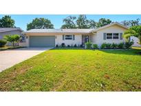 Charming home features a well-manicured front yard with lush green grass and a tidy exterior at 5647 110Th Way, Seminole, FL 33772