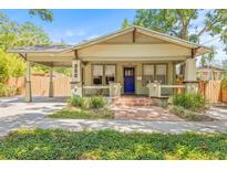 Charming home with brick walkway, welcoming porch, and carport at 906 E Broad St, Tampa, FL 33604
