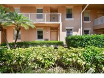 Inviting condo exterior featuring lush landscaping and neutral paint at 1003 Fairwaycove Ln # 103, Bradenton, FL 34212