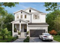 Charming two-story home featuring a brick facade, covered entry, black trim windows, and a two-car garage at 119 Huron Ave, Tampa, FL 33606