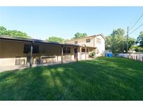 Expansive backyard featuring a covered patio and a well-maintained lawn at 18121 Geraci Rd, Lutz, FL 33548