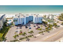 Stunning aerial view of a beachfront condo with a parking lot and views of the Gulf of Mexico at 18500 Gulf Blvd # 510, Indian Shores, FL 33785