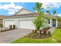 Charming single-story home with a three-car garage and a well-manicured lawn at 20423 Symphony Pl, Venice, FL 34293