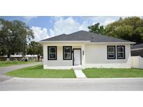 Charming single-story home with a well-manicured lawn and classic black and white trim at 2504 E 28Th Ave, Tampa, FL 33605