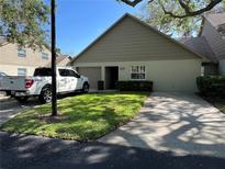 Inviting single-story home with a well-manicured lawn and a private driveway and garage at 2826 Rampart Cir, Clearwater, FL 33761