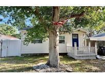 Charming single-story home with white siding, a blue front door, and a cozy porch at 3970 56Th Ave N, St Petersburg, FL 33714