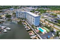 Stunning aerial view of waterfront condo with marina, pool, and meticulous landscaping at 4939 Floramar Ter # 504, New Port Richey, FL 34652