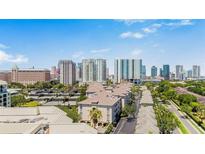 Aerial shot of condo complex with a cityscape backdrop and lush green landscaping at 501 Knights Run Ave # 1335, Tampa, FL 33602