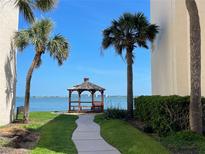 Scenic view of a beautiful wooden gazebo with a view of the water and tropical palm trees at 5736 La Puerta Del Sol S Blvd # 254, St Petersburg, FL 33715