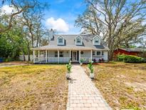 Charming single-story home featuring a welcoming front porch and a well-manicured front yard at 10206 N Hyaleah Rd, Tampa, FL 33617
