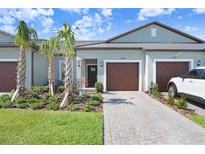 Charming villa featuring a well maintained front yard and an attached garage at 10998 Gable Dig Loop, San Antonio, FL 33576