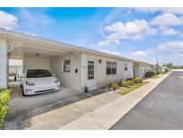 Charming single-story home with carport, brick facade, and manicured landscaping at 12400 Park Blvd # 210, Seminole, FL 33772