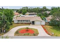 Charming single story home featuring a circular driveway and well-manicured landscaping at 14330 Oliver St, Largo, FL 33774