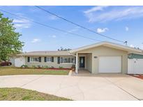 Charming single-story home with attached garage, well-maintained lawn, and inviting curb appeal at 14330 Oliver St, Largo, FL 33774